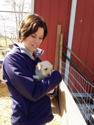 First Time Dog Mom shown holding her Golden Retriever puppy.